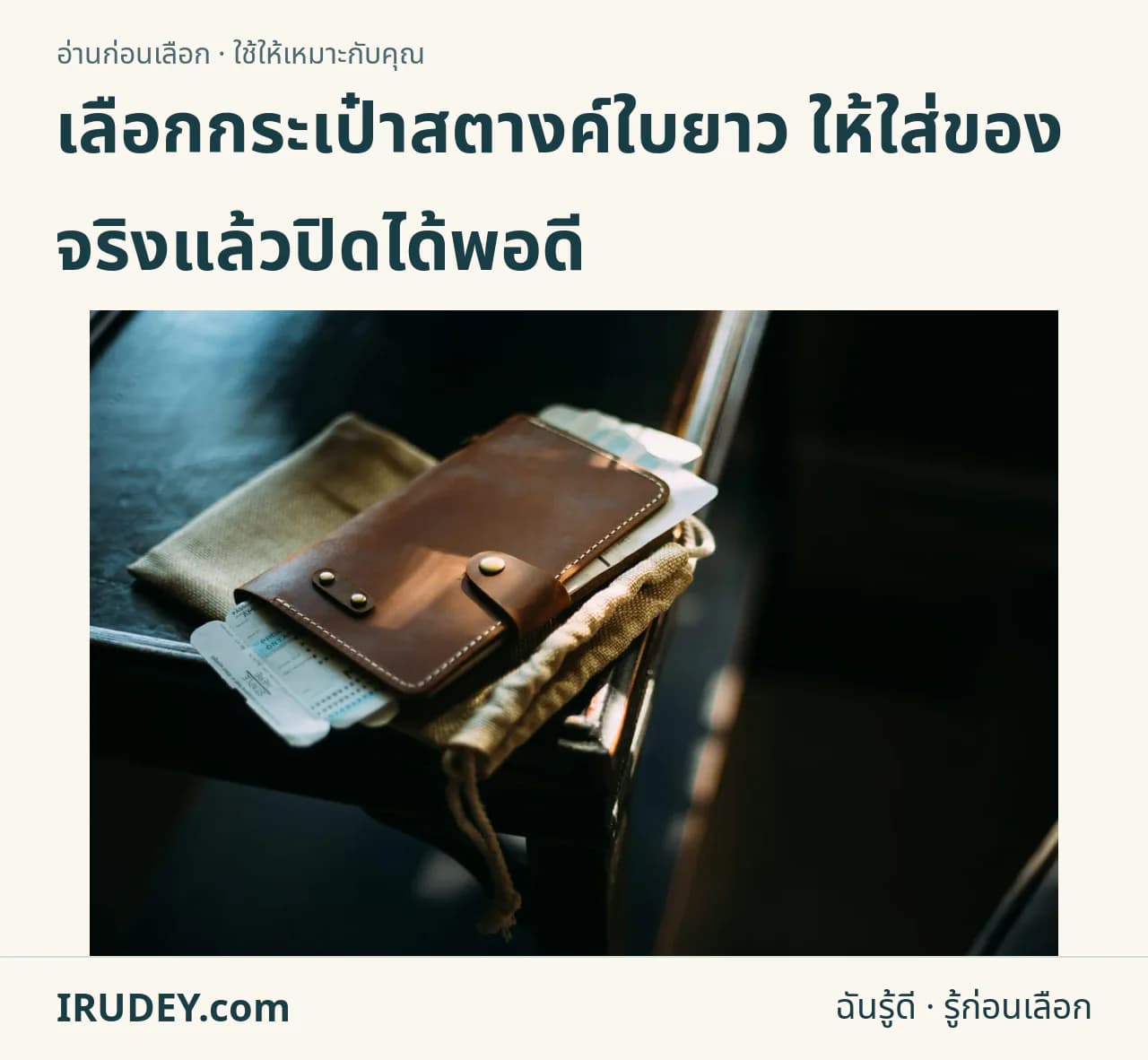 กระเป๋าใบยาวสีน้ำตาลมีสายปิด วางร่วมกับเอกสารเดินทาง